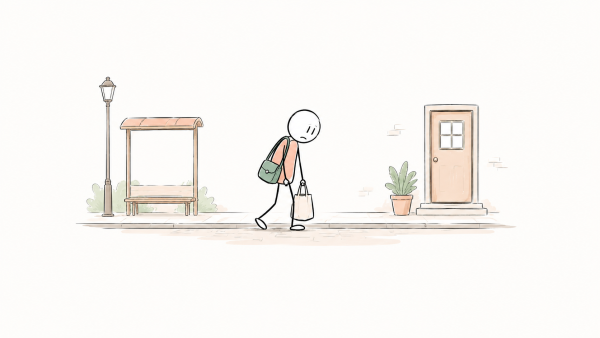 Sur le chemin du retour du travail, une personne avance péniblement, les épaules affaissées sous le poids de ses sacs.